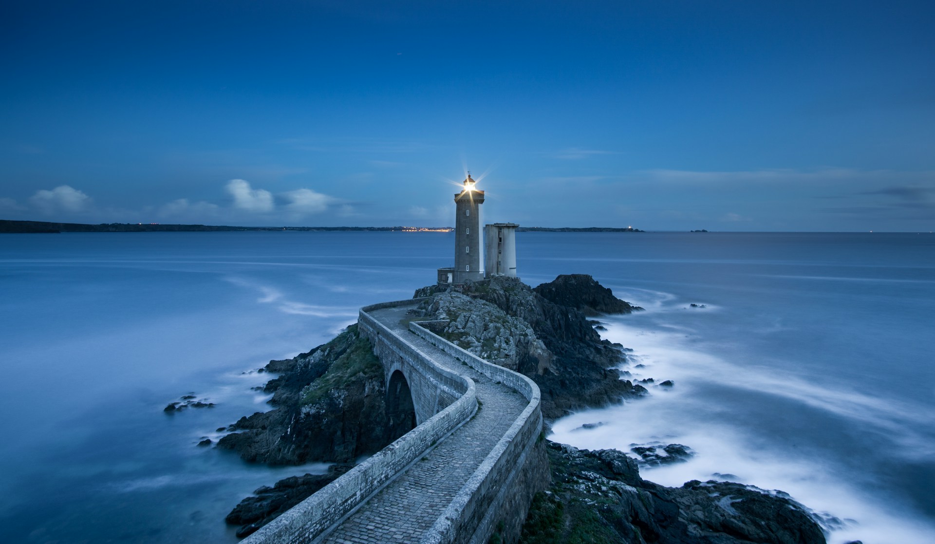 Lighthouse on a rocky coast at dusk, illustrating clarity in measuring AI visibility and brand representation